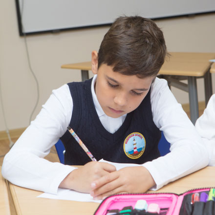 A Riverside School pupil working on a writing task